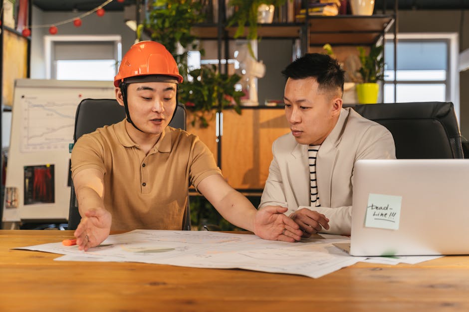 Consultant reviewing warehouse layout drawings with an e-commerce business owner